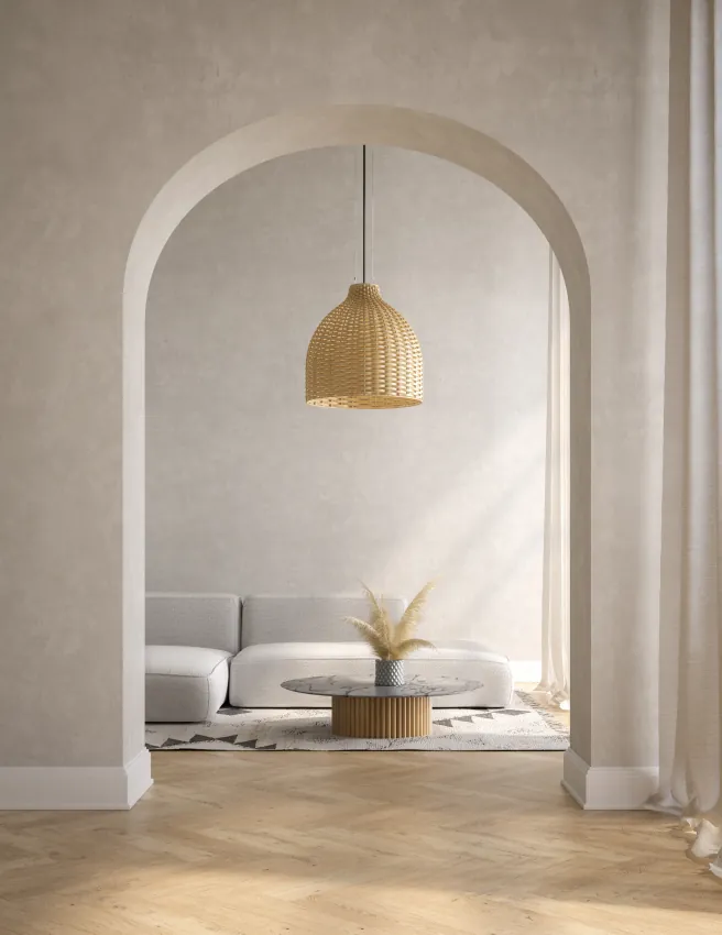 Arched doorway opening onto a minimalist living room with a white sofa and rattan pendant