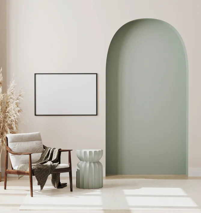 Minimalist interior with a sage-green arched alcove, wooden lounge chair and framed print