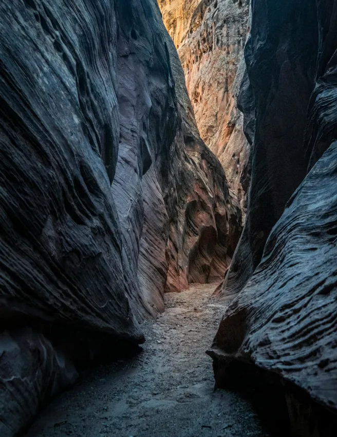 Narrow slot canyon with blue-grey rock walls